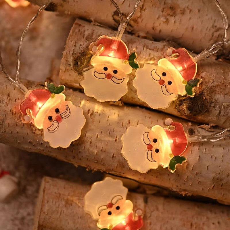 Glowing LED snowman face ornaments on a string light cord