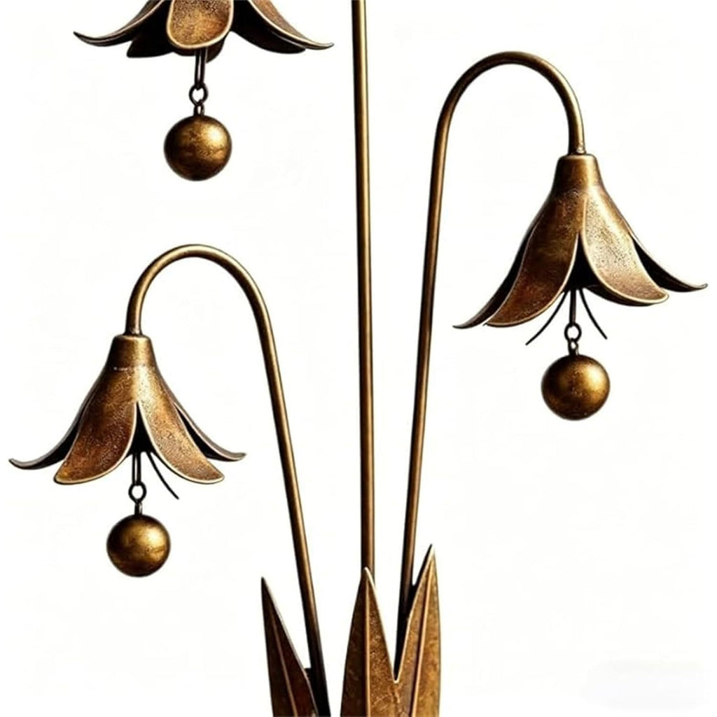Copper-tone bellflower garden stake detail with flower cups and round hanging ornaments