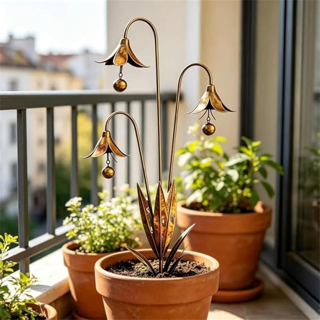 Copper-tone metal garden stake with three bellflower heads and hanging bead ornaments