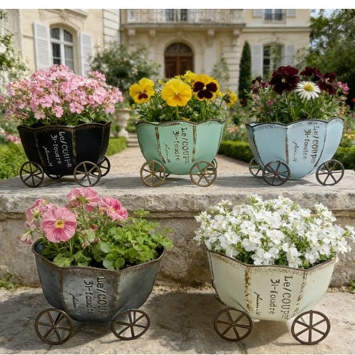 Vintage metal cart planters with wheels, holding pink, yellow, and white flowers