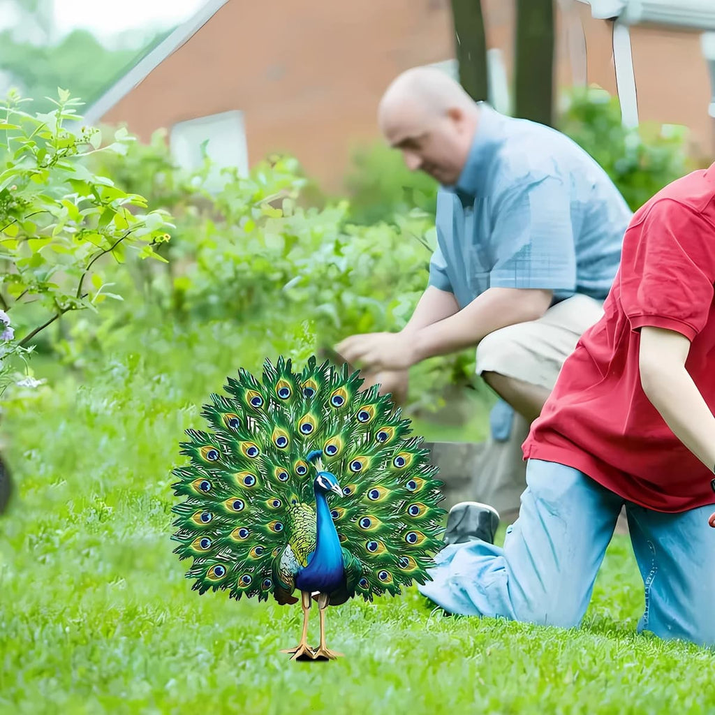 Green and blue peacock 2D flat stake with black pointed base in the lawn