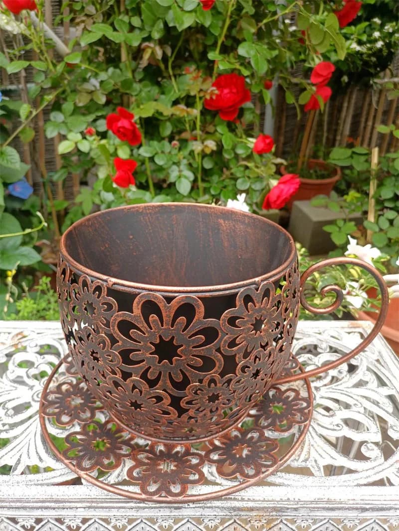 Vintage Floral Cutout Metal Teacup Planter – Rustic Iron Cachepot with Saucer Base & Scrolled Handle (11" Wide)