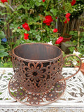 Vintage Floral Cutout Metal Teacup Planter – Rustic Iron Cachepot with Saucer Base & Scrolled Handle (11" Wide)