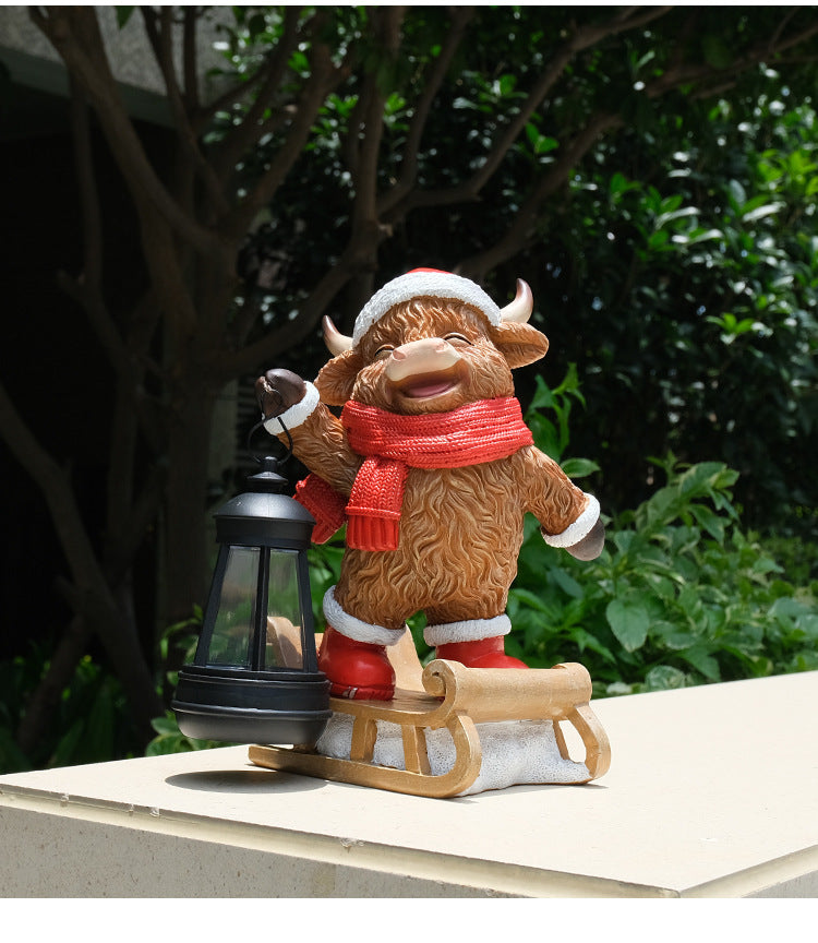 Hand-painted cow solar lantern statue on sleigh, red scarf, white hat and black lantern