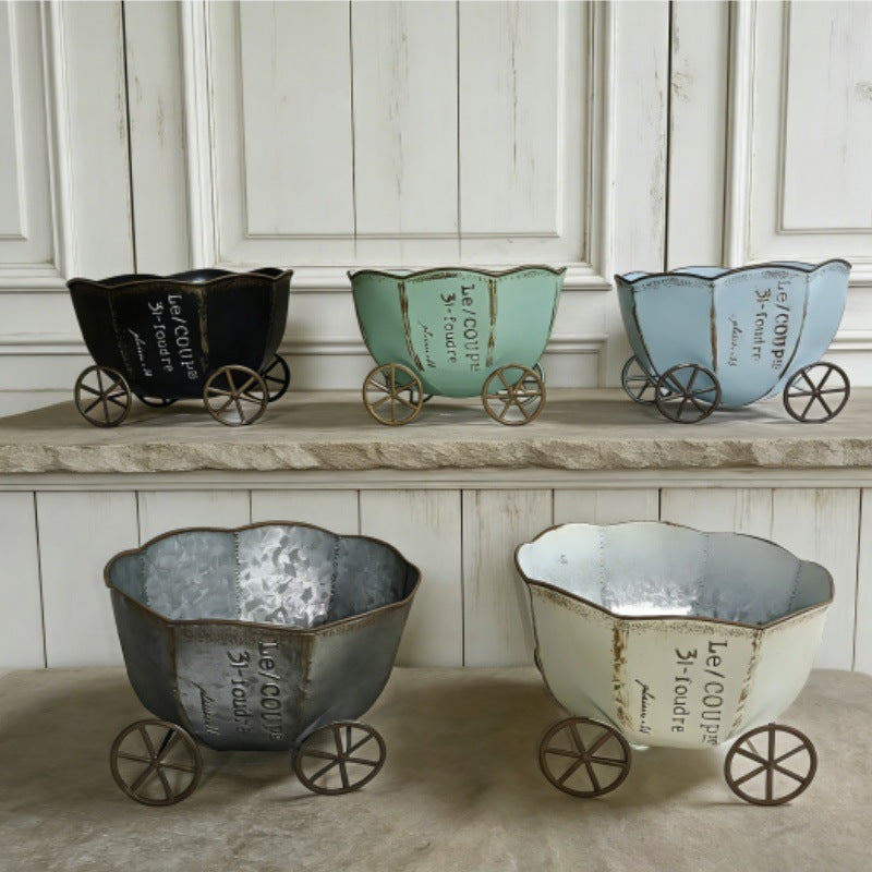 Vintage metal cart planters with wheels in dark, mint, and light tones