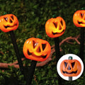 Halloween LED pumpkin stake lights, glowing jack-o'-lanterns on black stakes