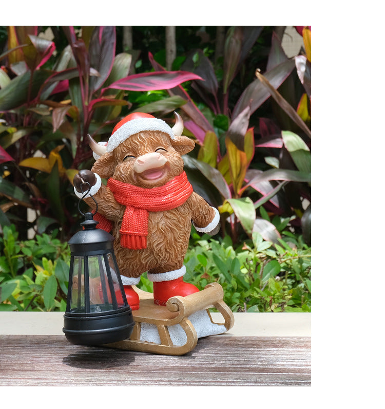 Hand-painted cow solar lantern statue with black lantern, red scarf, white-trimmed hat