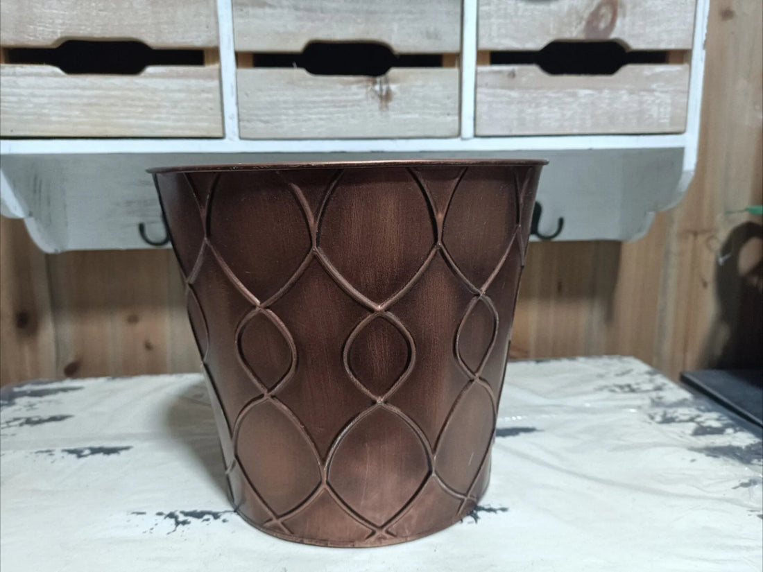 Brown iron planter bucket with embossed diamond pattern, straight-on front view