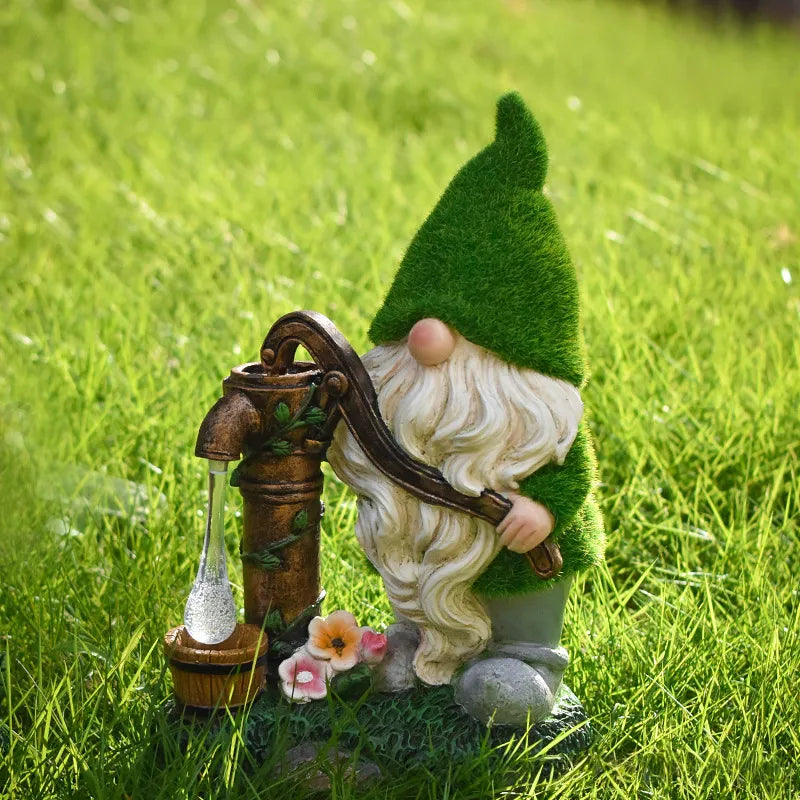 Resin garden gnome with green hat holding a bronze lantern