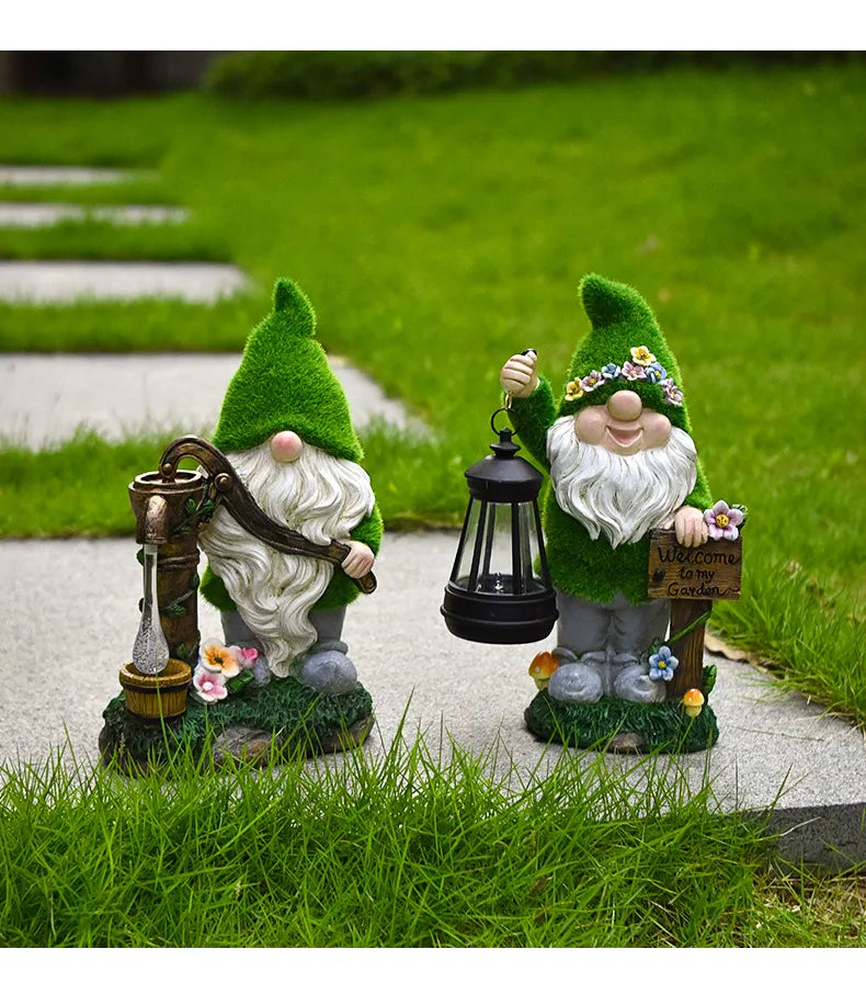 Two resin gnomes with green hats and black solar lanterns