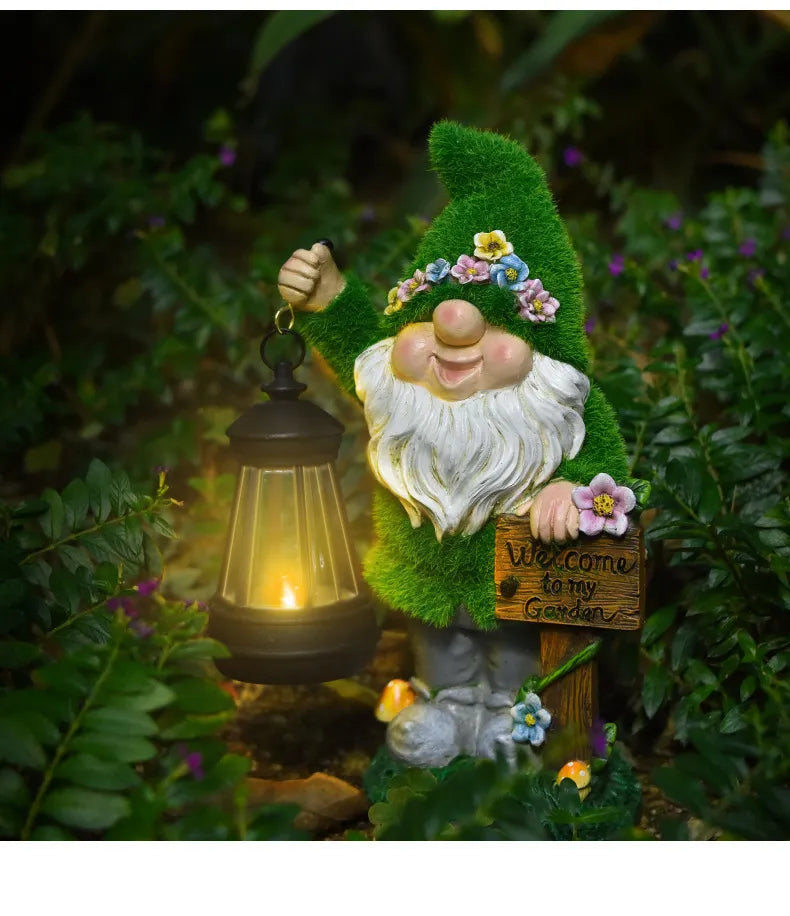 Resin garden gnome with glowing LED black lantern, green hat, white beard, flower garland.
