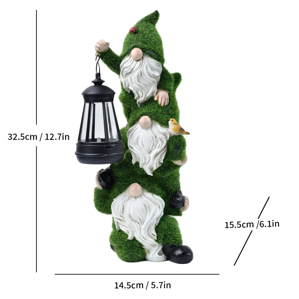 Stacked resin gnome trio with green hats and black solar lanterns