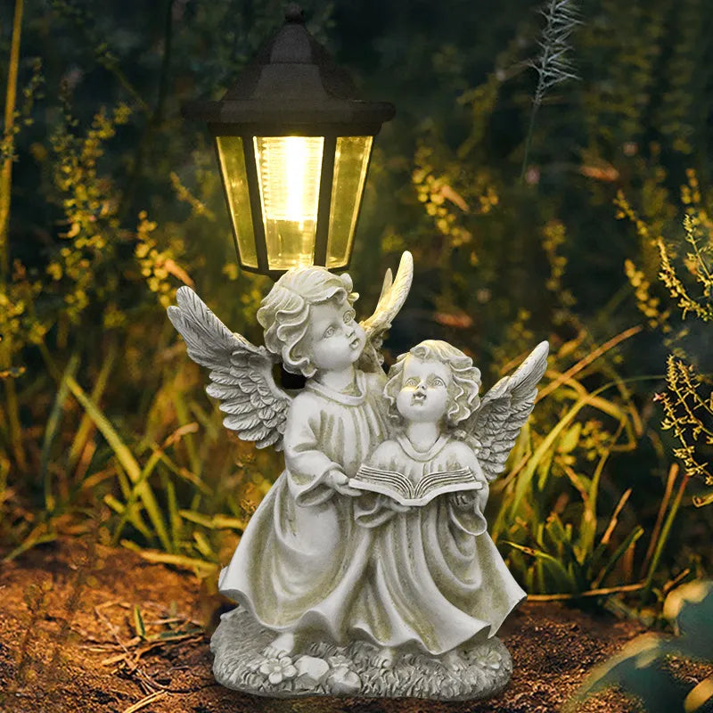 Hand-painted resin double angel statue with LED lantern, wings outstretched and holding a book