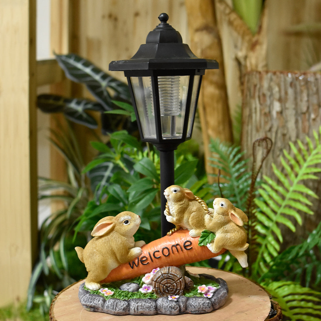 Solar LED rabbit garden statue with black lantern, three tan rabbits, and welcome sign on base