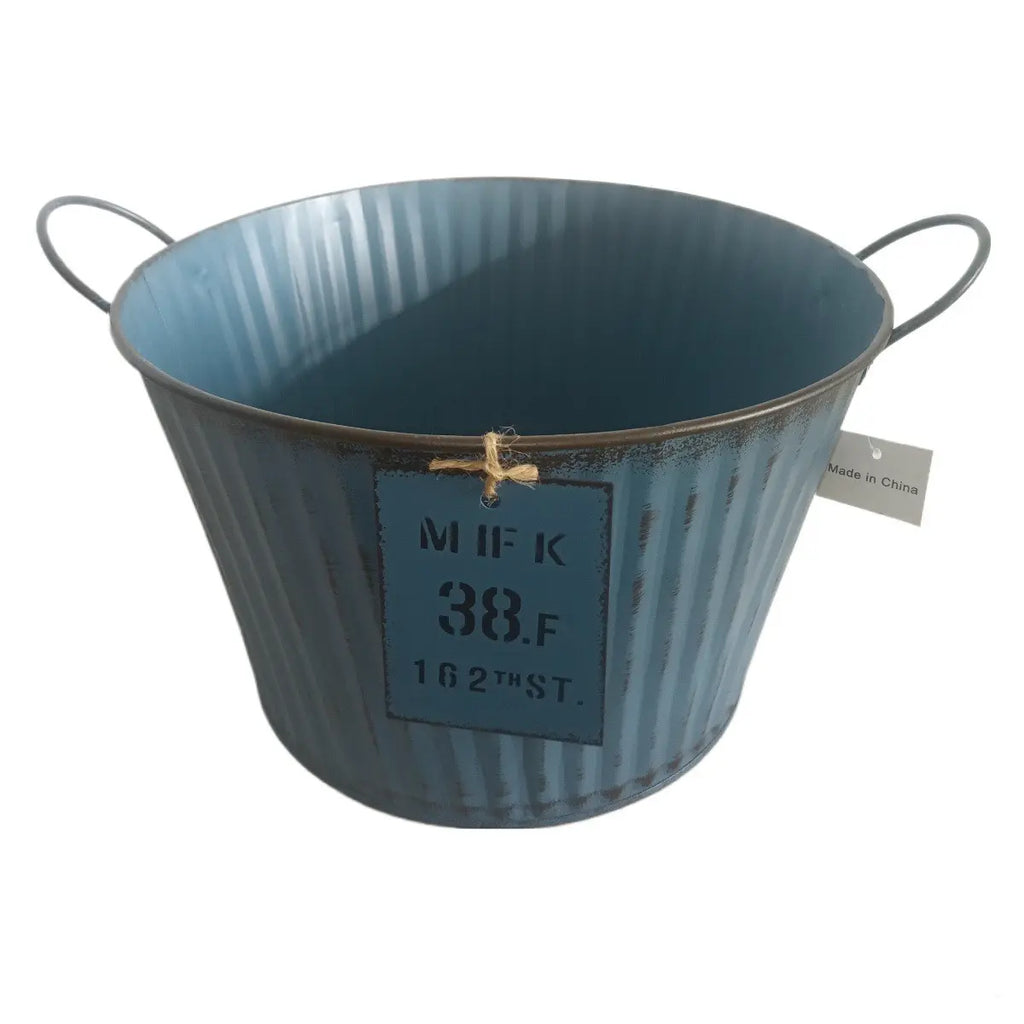 Blue metal bucket with handles on a white background