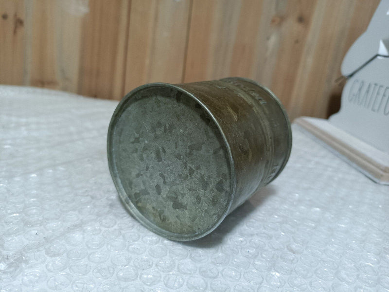 Old metal can on a bubble wrap surface with a wooden background