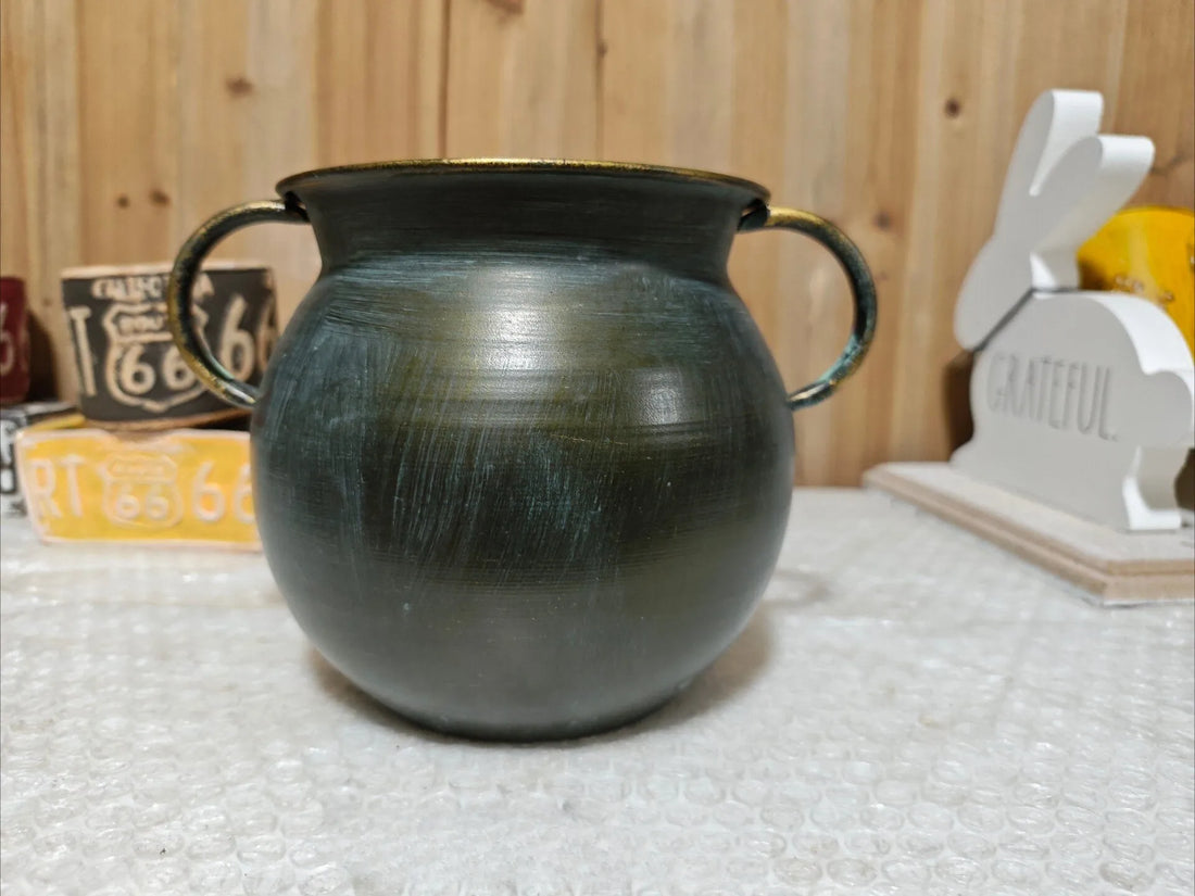 Bronze iron planter pot with two curved handles and smooth rounded body