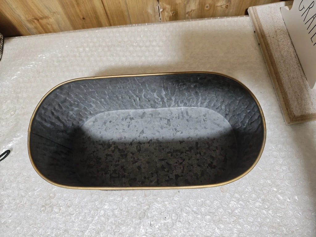Oval metal planter with faux bark texture and gold rim, dark charcoal finish