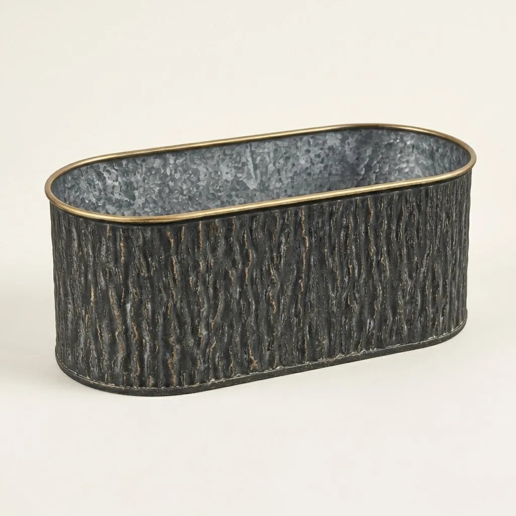 Oval metal planter with faux bark texture and gold rim, dark charcoal exterior