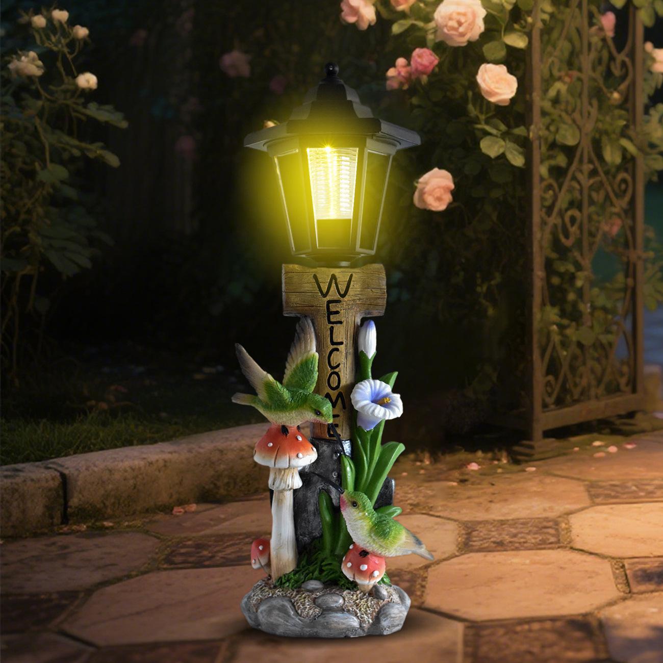 Decorative garden light with mushrooms and flowers on a stone path