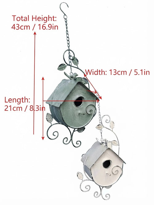 Hanging metal birdhouse set with green and white finishes; round entry holes and scroll frame.