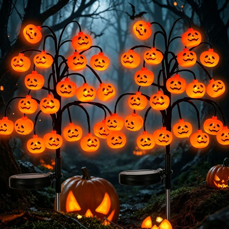 Luces solares con forma de calabaza de Halloween, con 20 caras de calabaza LED naranjas, montadas en estacas para jardín.