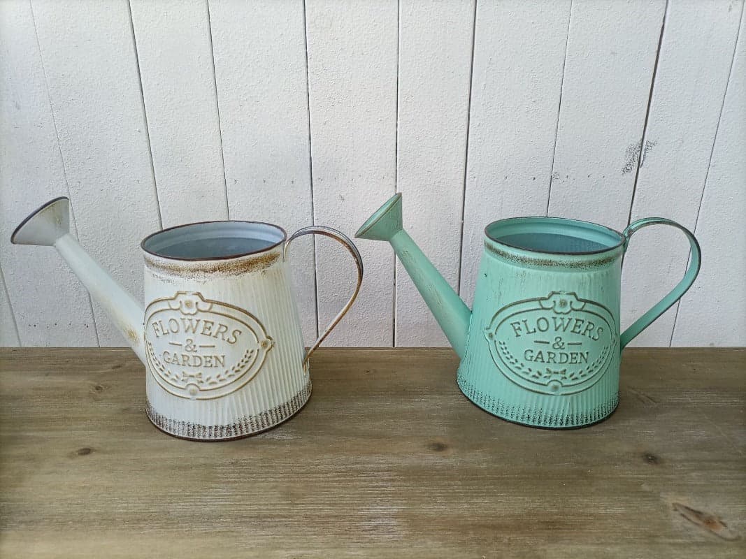 Vintage metal watering can vase set in white and mint-green with dark interiors