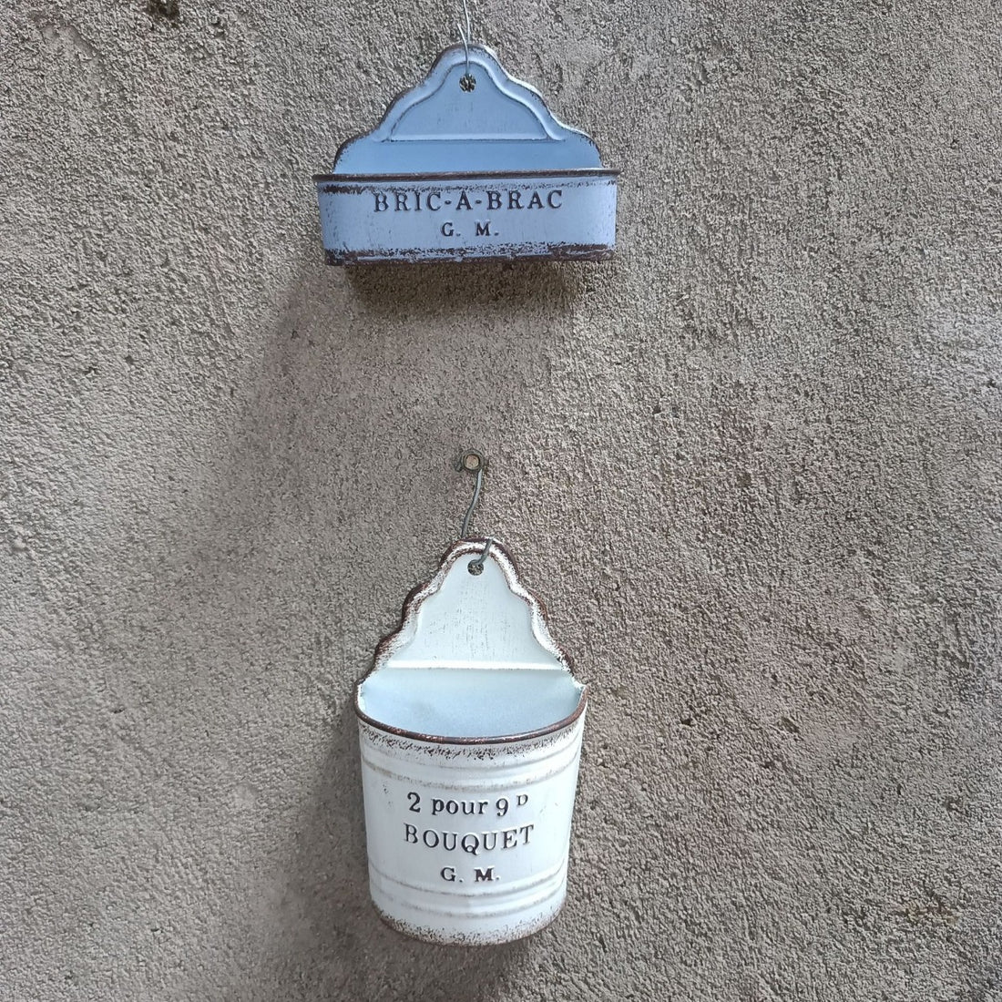 Two hanging metal wall planters: “BRIC-A-BRAC G.M.” and “2 pour 9D BOUQUET G.M.”