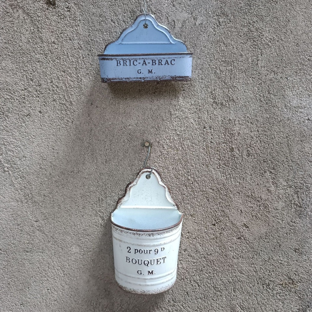 Two hanging metal wall planters: “BRIC-A-BRAC G.M.” and “2 pour 9D BOUQUET G.M.”