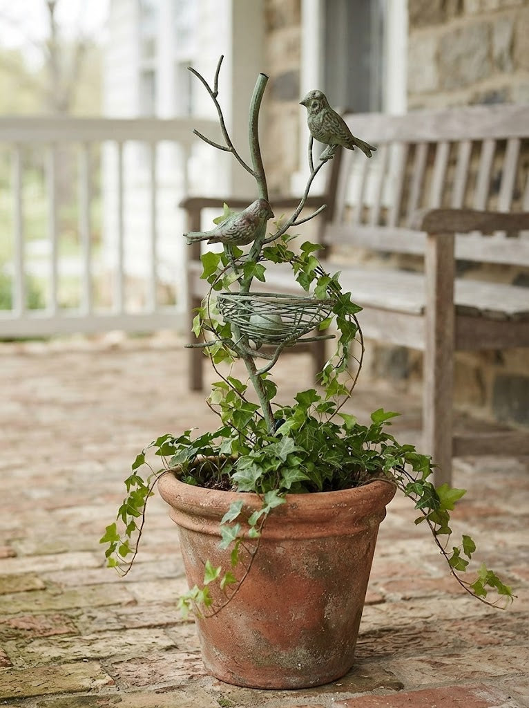 Metal garden stake trellis with perched birds and round wire nest basket, green patina