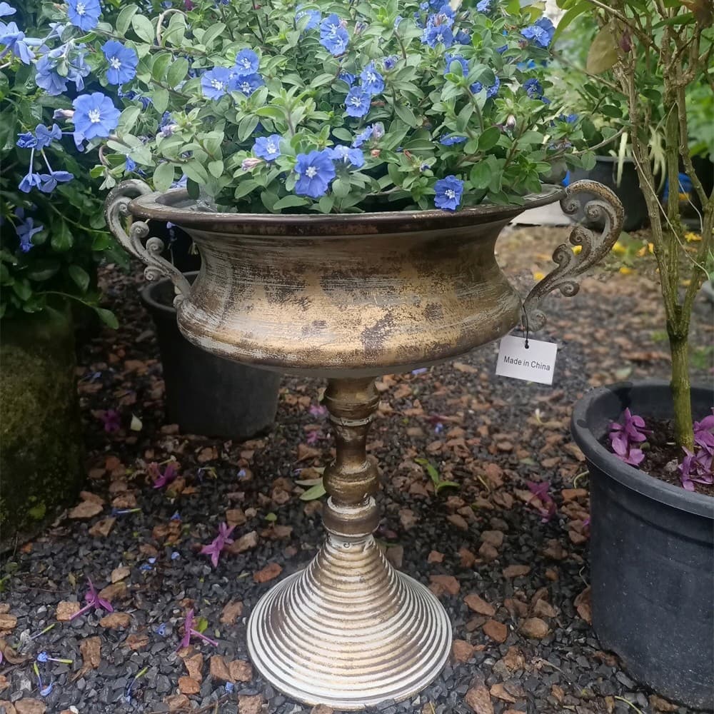 Antique gold pedestal planter urn with wide bowl, scroll handles, and ribbed stand