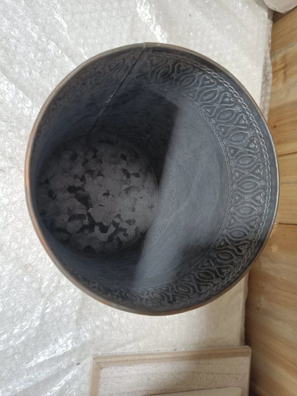 Gray metal storage bucket with ornate embossed lid, round top, rustic textured finish